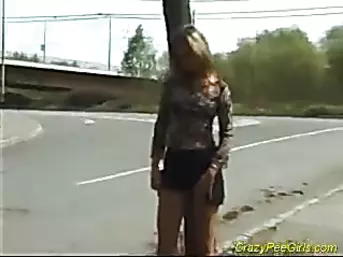 Blonde pees on road