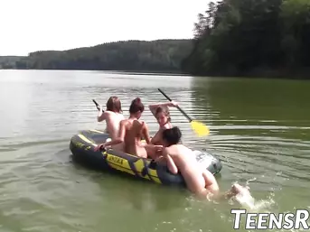 Group of naughty teens is having fun while swimming outdoor