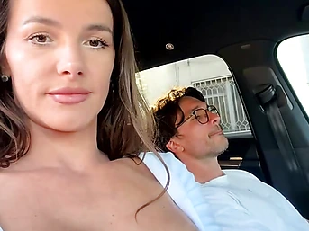 Sexy brunette babe plays with boyfriend's cock in car ride