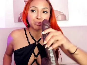 Stunning Redhead Deepthroats Massive Dildo on Couch